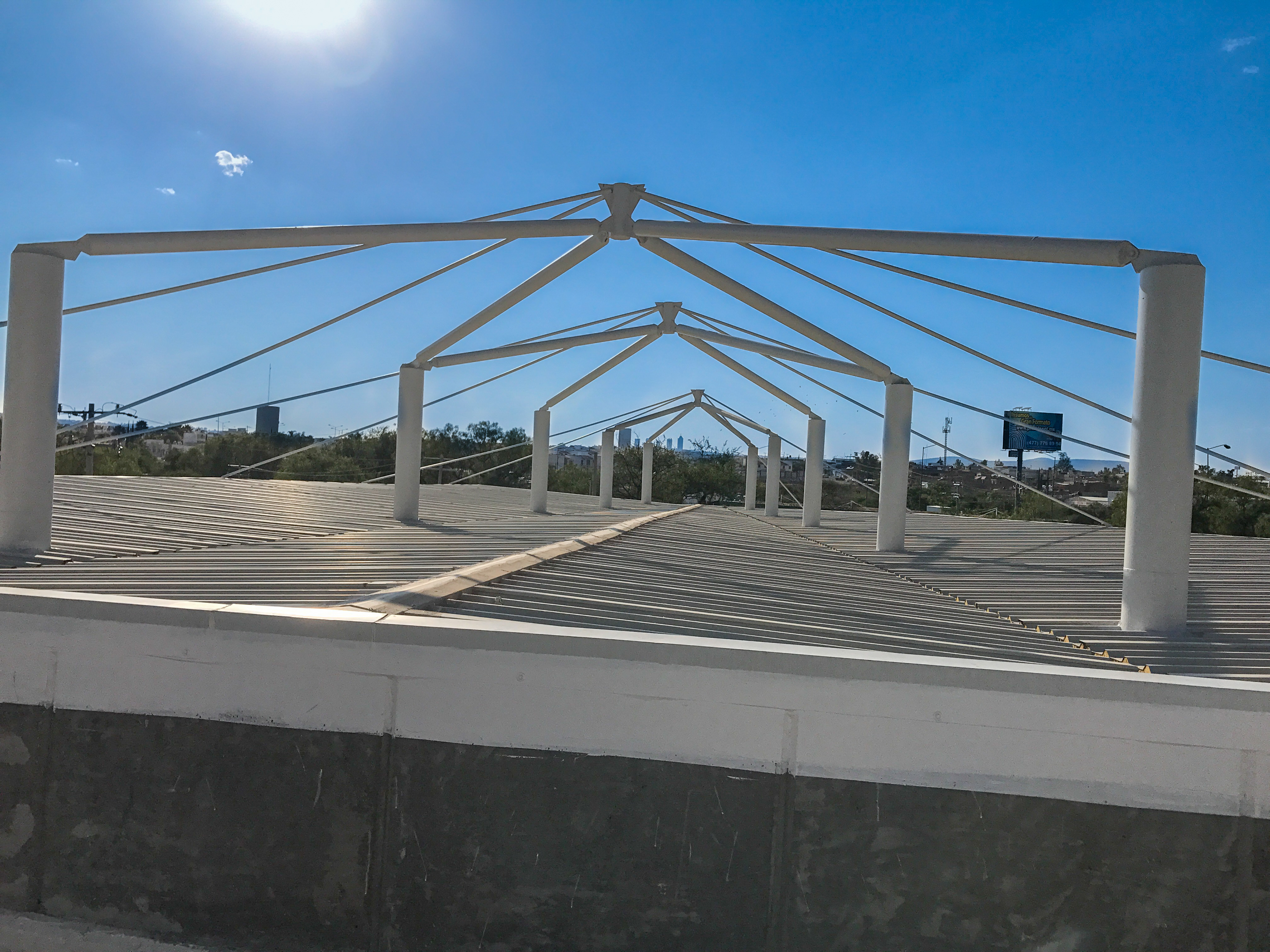 Exterior de estructura metálica SIT con cubierta de lámina y cielo abierto, constructora Fer Et Ciment León